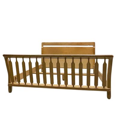 wooden bed frame with spindles and rails on a white background