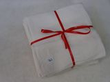 a white napkin with a red ribbon tied to it