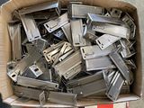 a cardboard box full of metal parts sitting on the floor