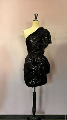 a black dress on a mannequin on a stand