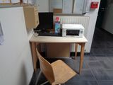 a desk with a chair and a computer on it