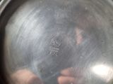 a person taking a picture of a silver pan