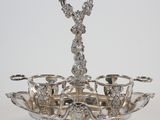 a silver plate with three cups and a spoon on it