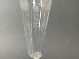 a glass vase with a snake on it on a table