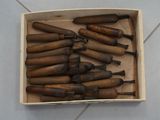 a box full of wooden tools on a tile floor