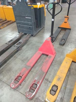 several forklifts and pallets are lined up in a warehouse