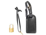a black luggage tag with a brass lock on a white background