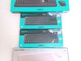 three boxes of computer keyboards sitting on top of each other