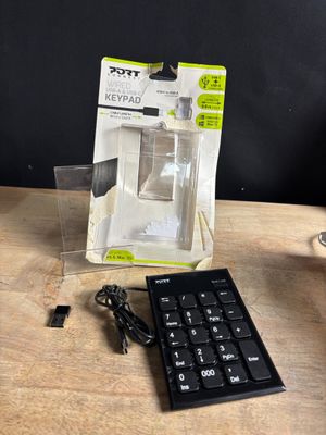 a remote control sitting on a table next to a keyboard