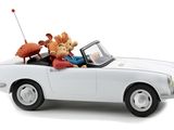 a white toy car with a man and a dog in it