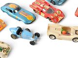 many toy cars that are lined up together on a white surface