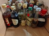 many bottles of liquor in a box on the floor