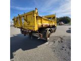 an image of a yellow dump truck parked in a parking lot