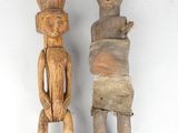 pair of carved wooden figurines of a man and a woman