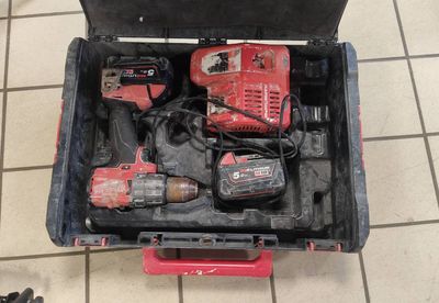 a tool box with tools in it on a tiled floor