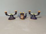 three blue and yellow vases sitting on a table