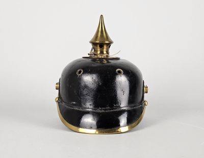 un vieux casque noir et doré, surmonté d'une crête dorée à pointes