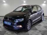 the black volkswagen polo estate is parked in a room with a checkered floor