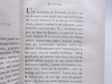 a close up of an open book on a white surface