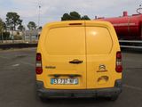 a yellow van that is parked in a parking lot
