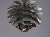 a metal light hanging from a ceiling in a room