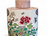 a vase with a lid that has flowers and birds on it