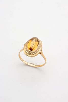 a gold ring with a citrine stone in the center