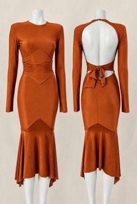 two mannequins wearing orange dresses with long sleeves and a cut out back