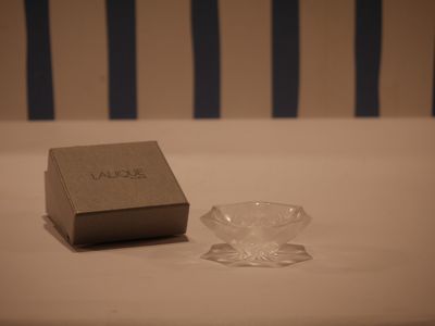a small glass bowl next to a small glass bowl on a table