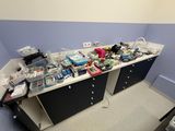 a cluttered desk in a small room with a lot of clutter on it