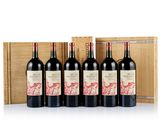 four bottles of red wine in a wooden box
