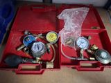 a red box with two gauges and a couple of gauges in it