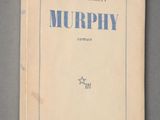 an old book with blue writing on it sitting on top of a table