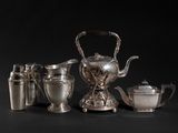 an image of a silver tea set with a teapot and cups