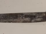 a knife that is laying on a white surface