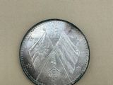 a close up of a coin on a table with a white background