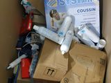 a cardboard box filled with toothbrushes, toothpaste, toothpaste, toothpaste, toothpaste, toothpaste, and