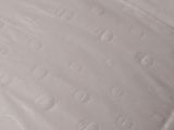 a close up of a mattress with a sheet on it