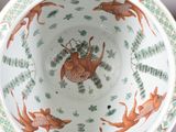 a bowl that has a picture of a deer and fish on it