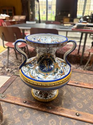 a blue and white vase sitting on top of a table