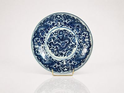 a blue and white plate with a dragon on it