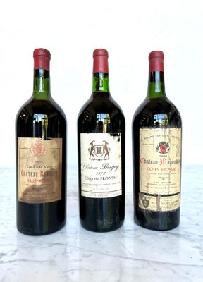 three bottles of wine sitting on a marble table