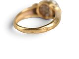 an image of a gold ring with a brown stone in the middle