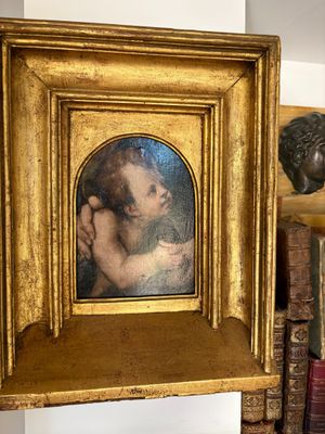 a picture of a woman holding a baby in a gold frame