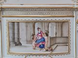 a miniature picture of a woman and a man sitting on a bench