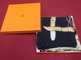 an orange box with a knife inside of it on a red surface