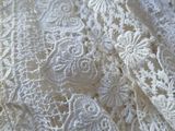 a close up of a white lace on a table