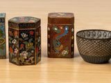four small vases sitting next to each other on a table