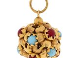 un gros plan d'un pendentif en or et turquoise sur fond blanc