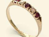 an image of a gold ring with rubies and diamonds